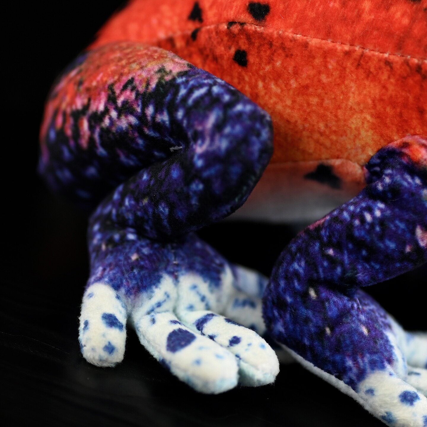 Detailed close-up of Blue Jeans Morph legs on the Strawberry Poison Dart Frog Plush, showcasing realistic colors