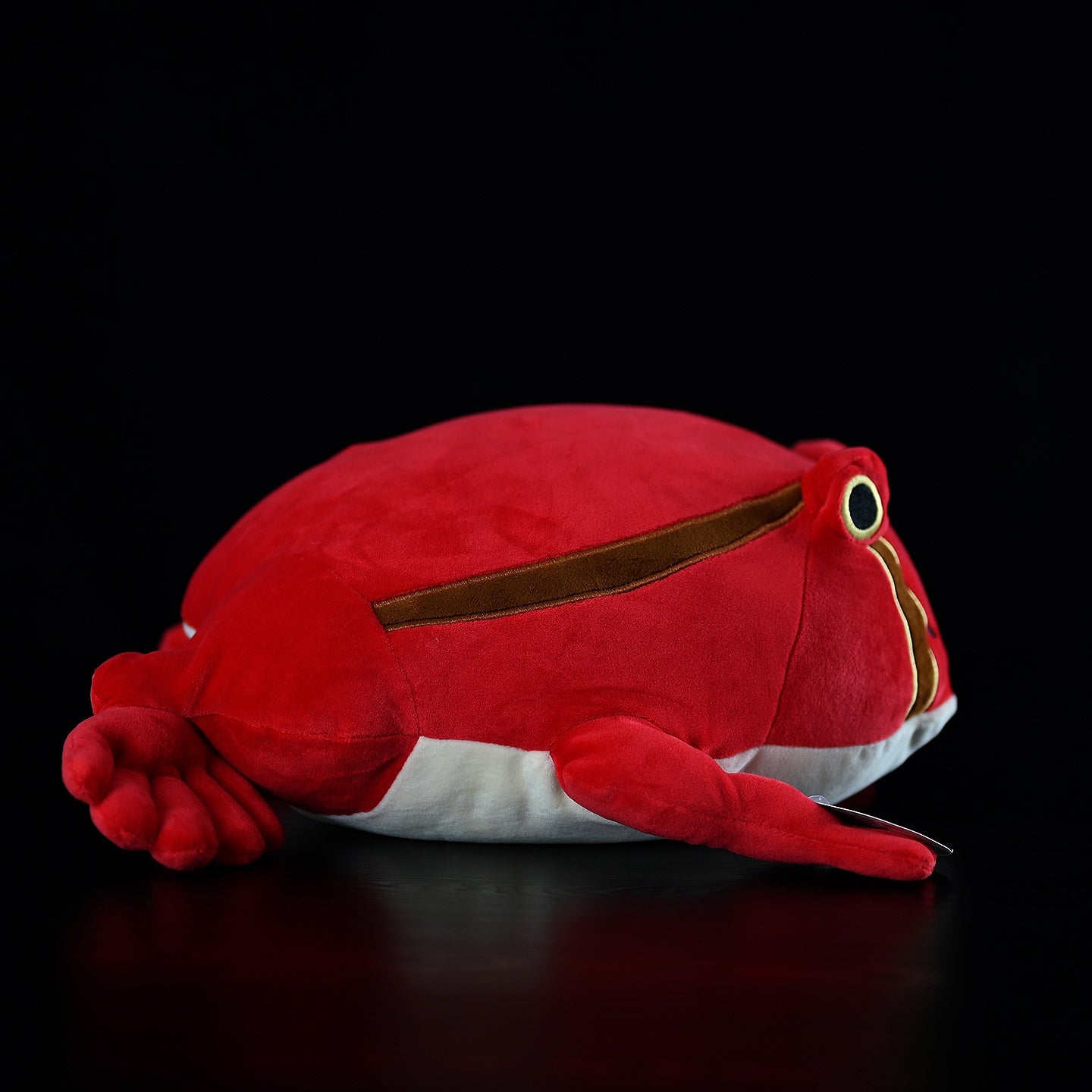 Side profile of Madagascar Tomato Frog plush, showing its vibrant colors and soft, lifelike fabric