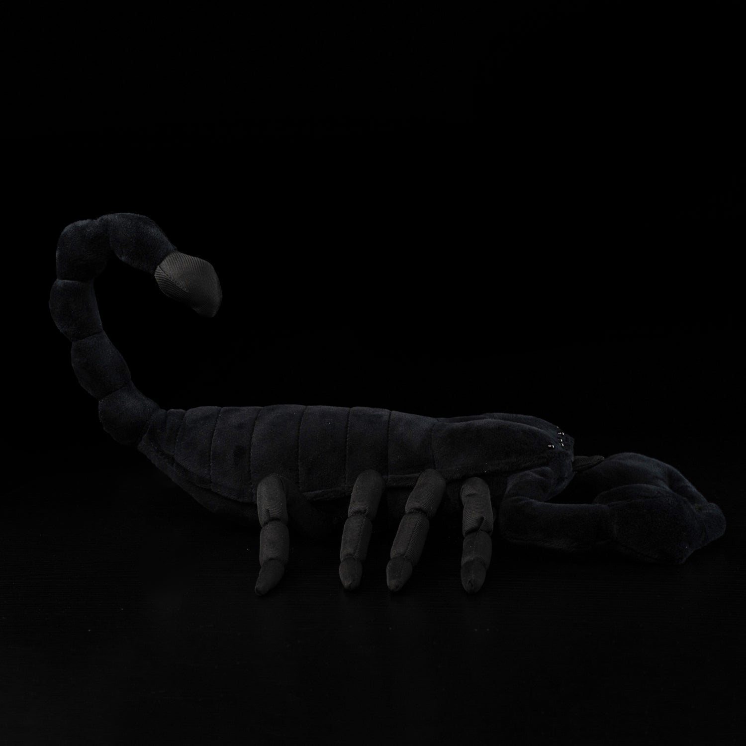 Side profile of Emperor Scorpion stuffed toy, showcasing its curled tail and lifelike appearance