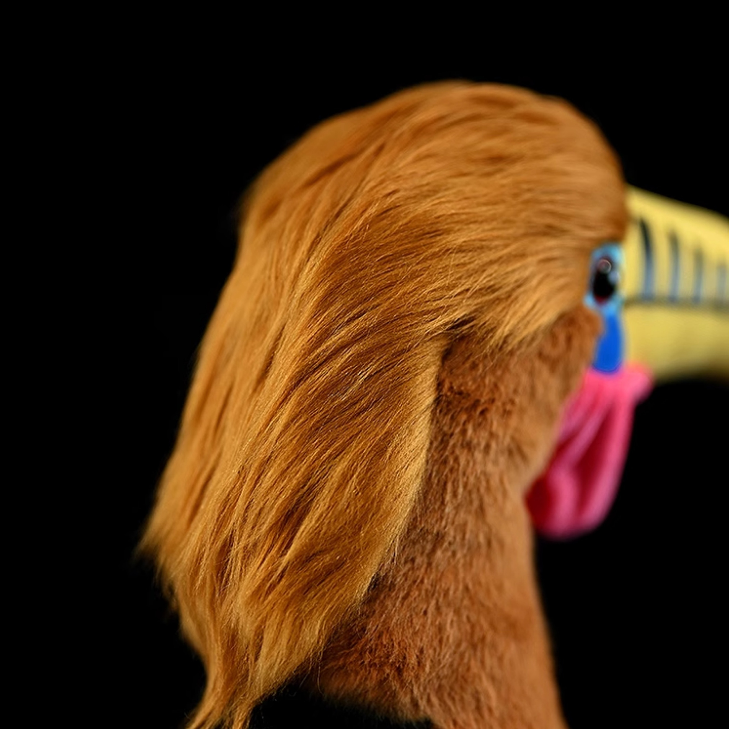 A close-up of the plush toy’s soft rufous feathers, showcasing its realistic and detailed design