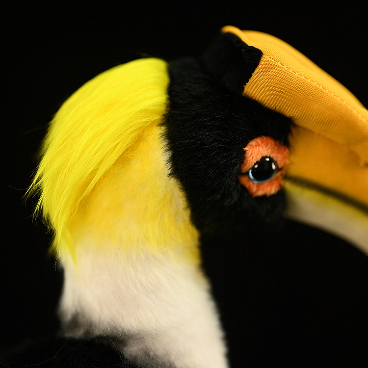 Close-up of the Great Hornbill plush toy with realistic head details, vibrant yellow feathers, and lifelike design