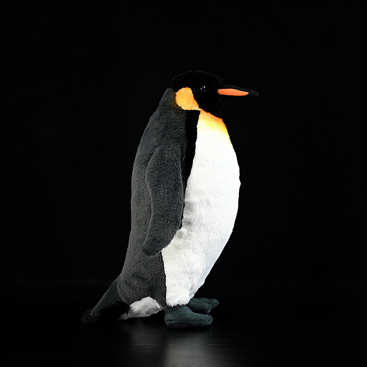 Side profile of a lifelike king penguin plush showcasing realistic features and soft grey texture