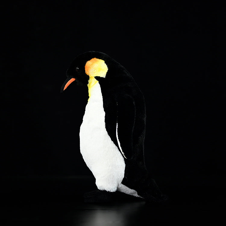 Side view of a lifelike emperor penguin plush toy, showcasing its detailed design and soft texture