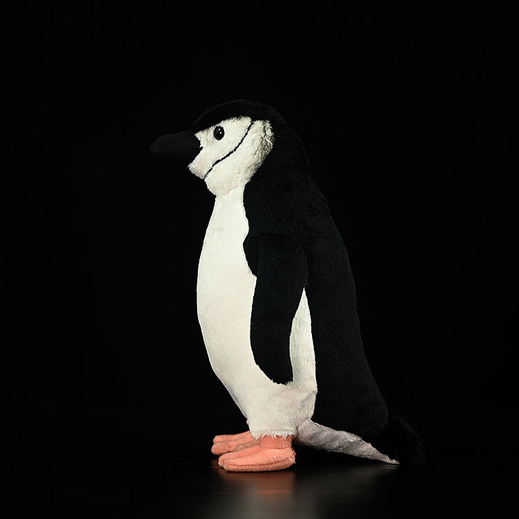 Side profile of a chinstrap penguin plush toy, displaying its sleek black-and-white design and adorable look
