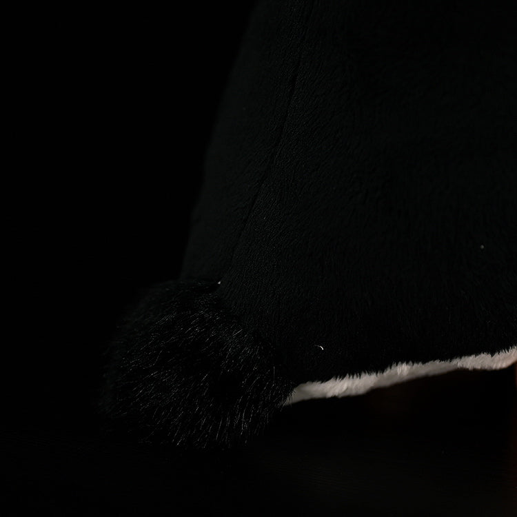 Detailed view of the tail of a chinstrap penguin plush toy, showcasing its soft and fluffy black texture