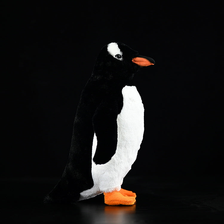 Side profile of Gentoo Penguin stuffed toy, lifelike black and white details with bright orange accents