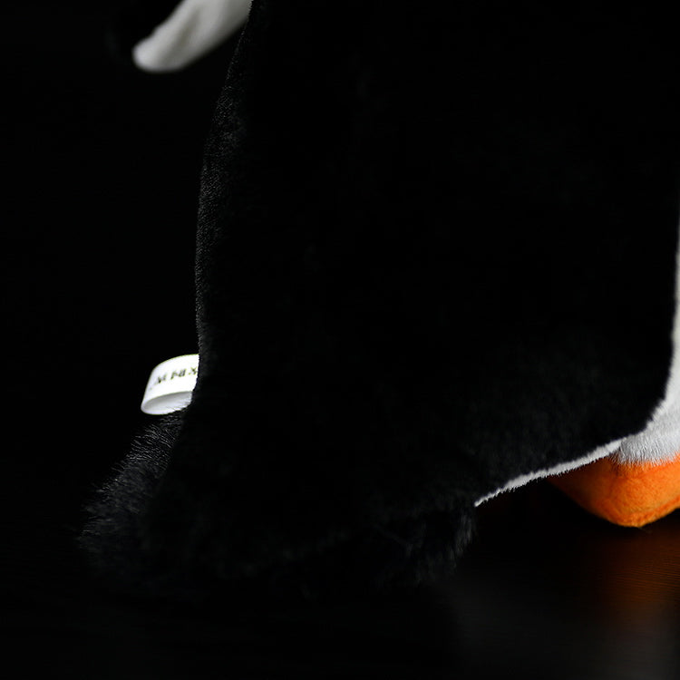 Tail section of Gentoo Penguin plush, showing soft black material and realistic penguin shape