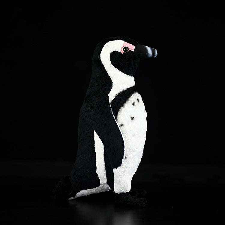 Side profile of African Penguin plush toy, highlighting its realistic black and white coloration