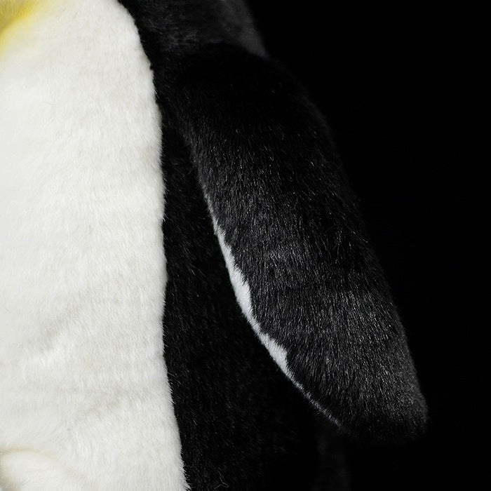 Close-up of emperor penguin plush flipper, showing soft material and realistic texture