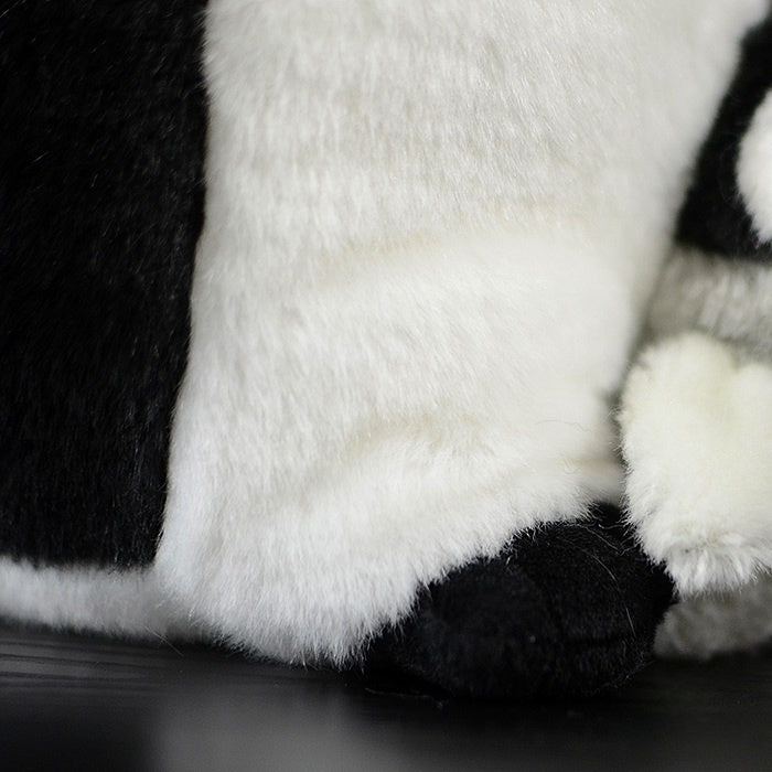 Detailed view of Mom & Baby emperor penguin plush feet, soft and designed for a lifelike appearance