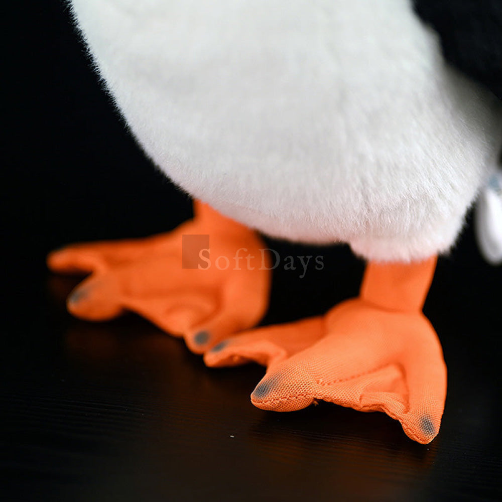 Close-up of the bright orange webbed feet of realistic Atlantic puffin plush toy