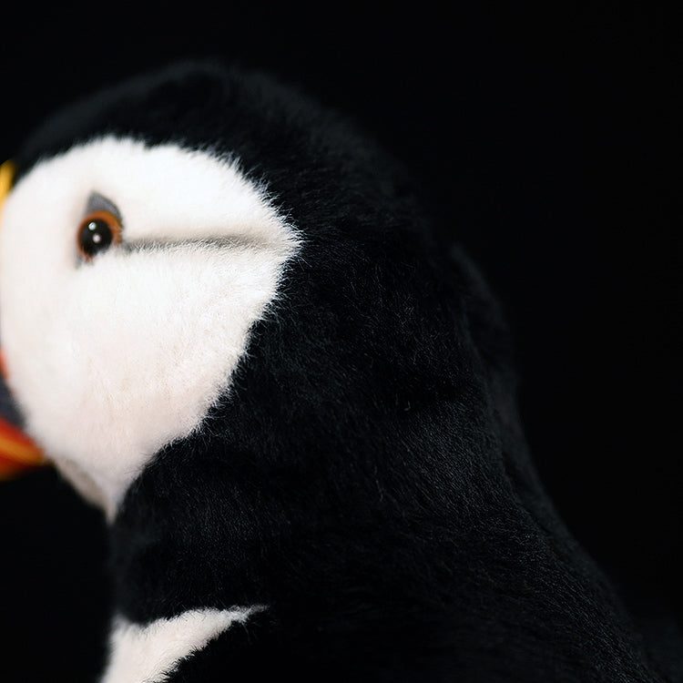 Side close-up of an Atlantic puffin plush toy’s head, highlighting soft textures and realistic details