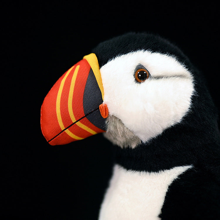 Vibrant close-up of an Atlantic puffin plush toy’s colorful beak and expressive eyes