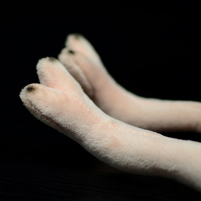 Close-up of ostrich plush toy’s legs, featuring soft material and detailed design for realism