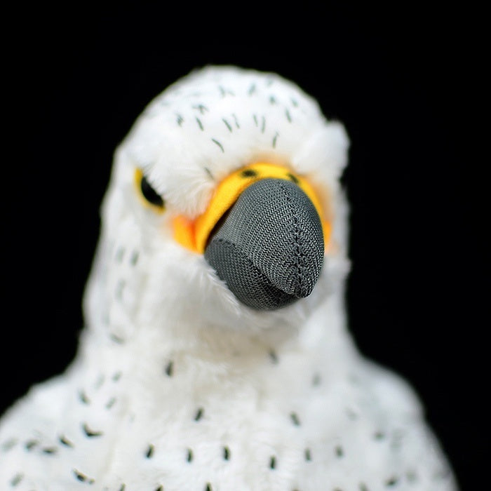 Close-up of a white gyrfalcon plush toy's face, showing realistic beak and eye details by SoftDaysLab