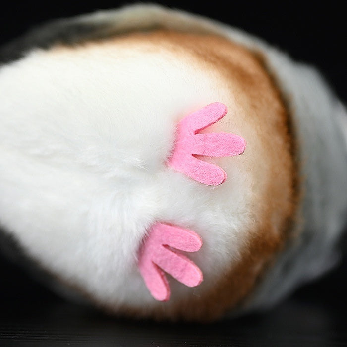 Bottom view of Java Sparrow bird plush, highlighting soft pink feet and attention to bird details