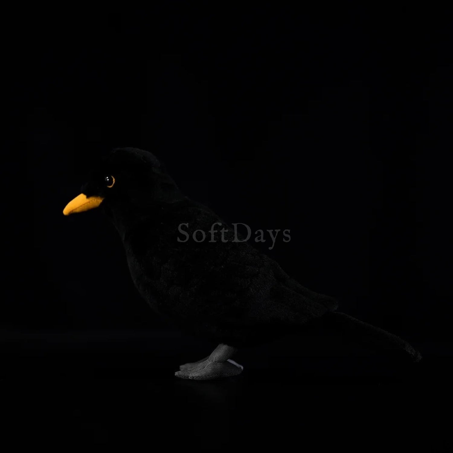 Eurasian Blackbird plush toy with soft black fabric, finely stitched gray feet, and realistic details