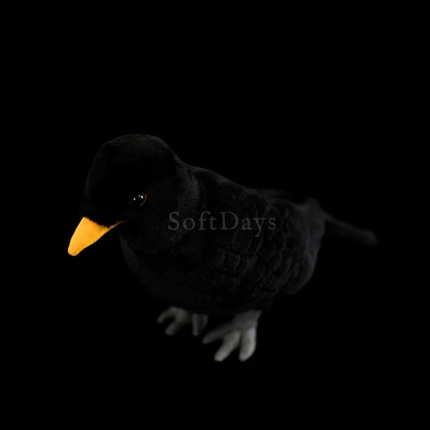 Eurasian Blackbird plush toy made with detailed black stitching, soft fur, and a bright yellow beak