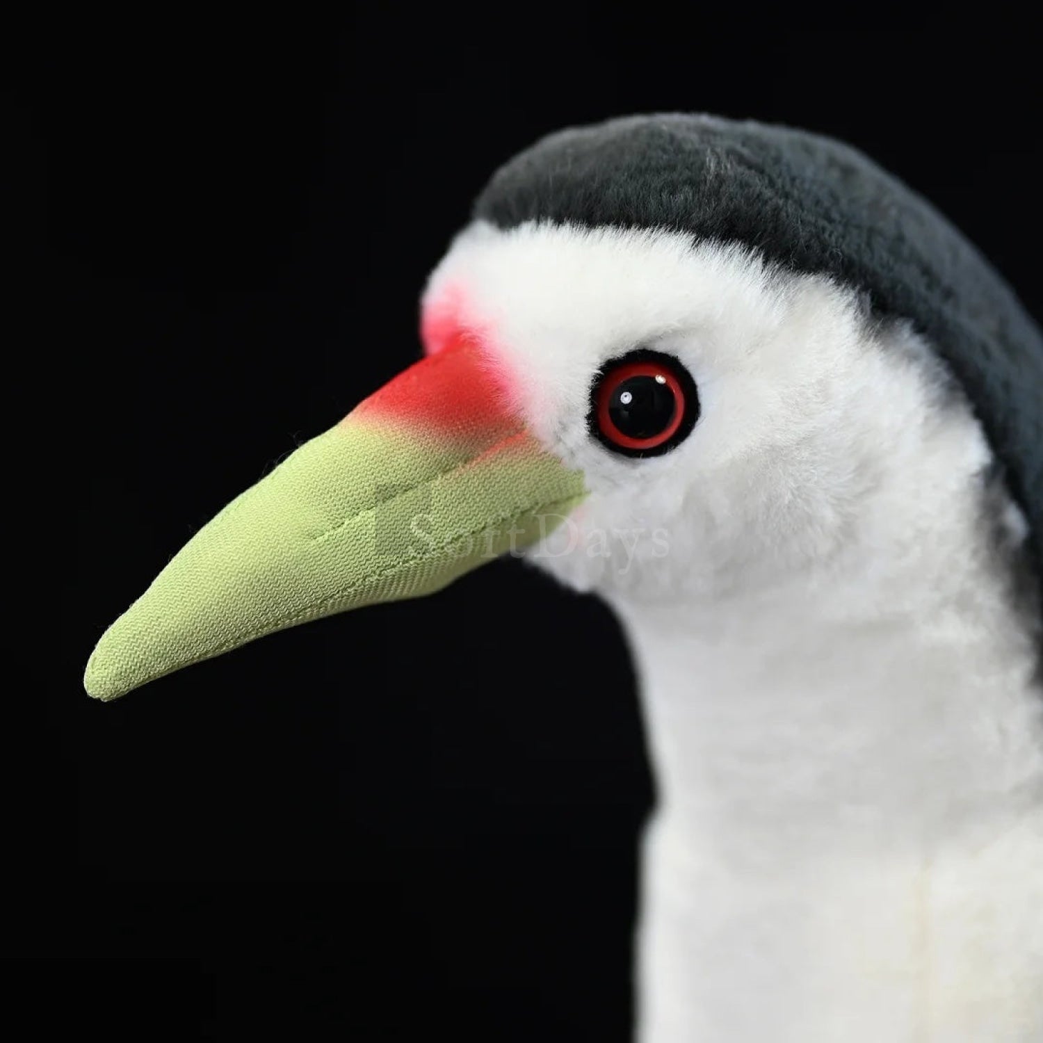 A detailed close-up of the White-breasted Waterhen plush, featuring a red-tipped green beak and vibrant red eyes