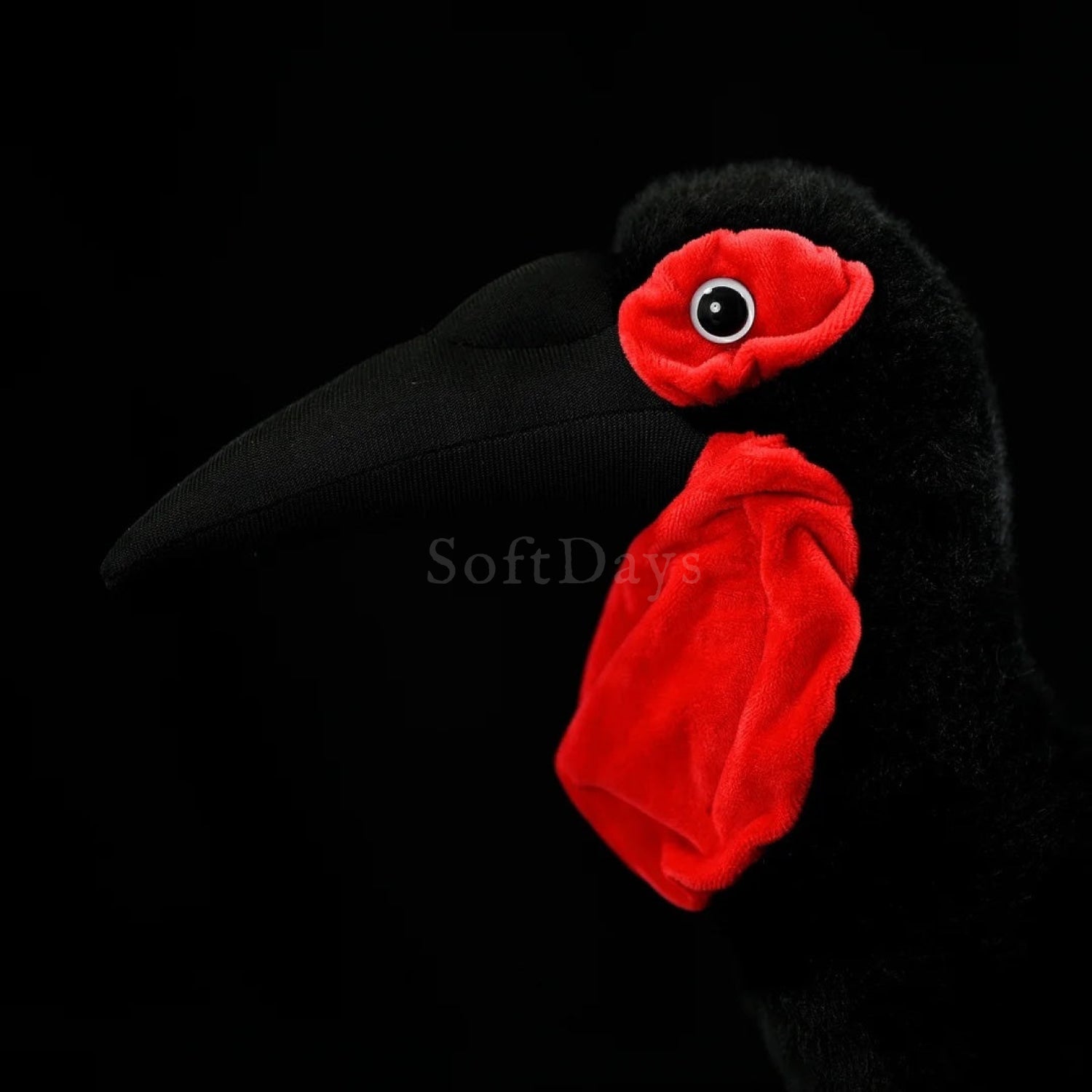 Close-up of Southern Ground Hornbill bird plush toy’s detailed black beak, red wattles, and lifelike design