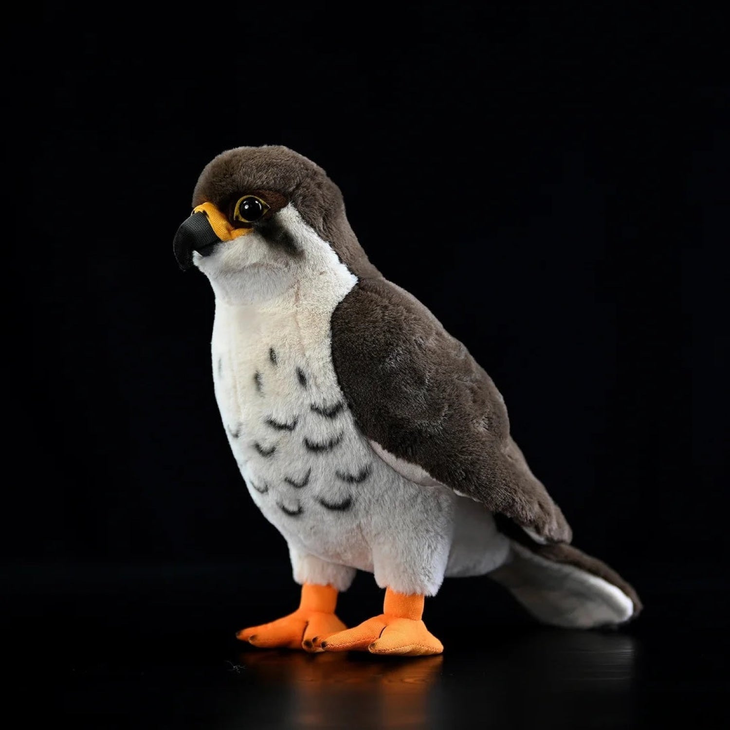 Realistic peregrine falcon plush toy with lifelike gray wings, white chest, and orange talons