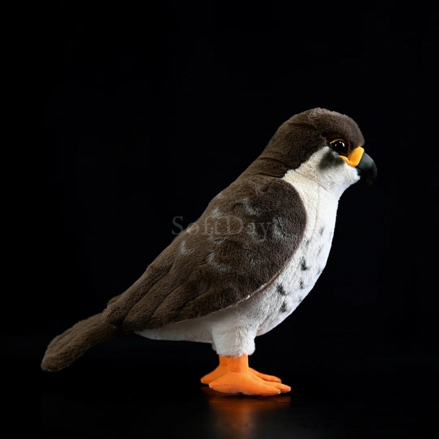 Lifelike peregrine falcon plush toy showing gray wings, white chest, and realistic posture