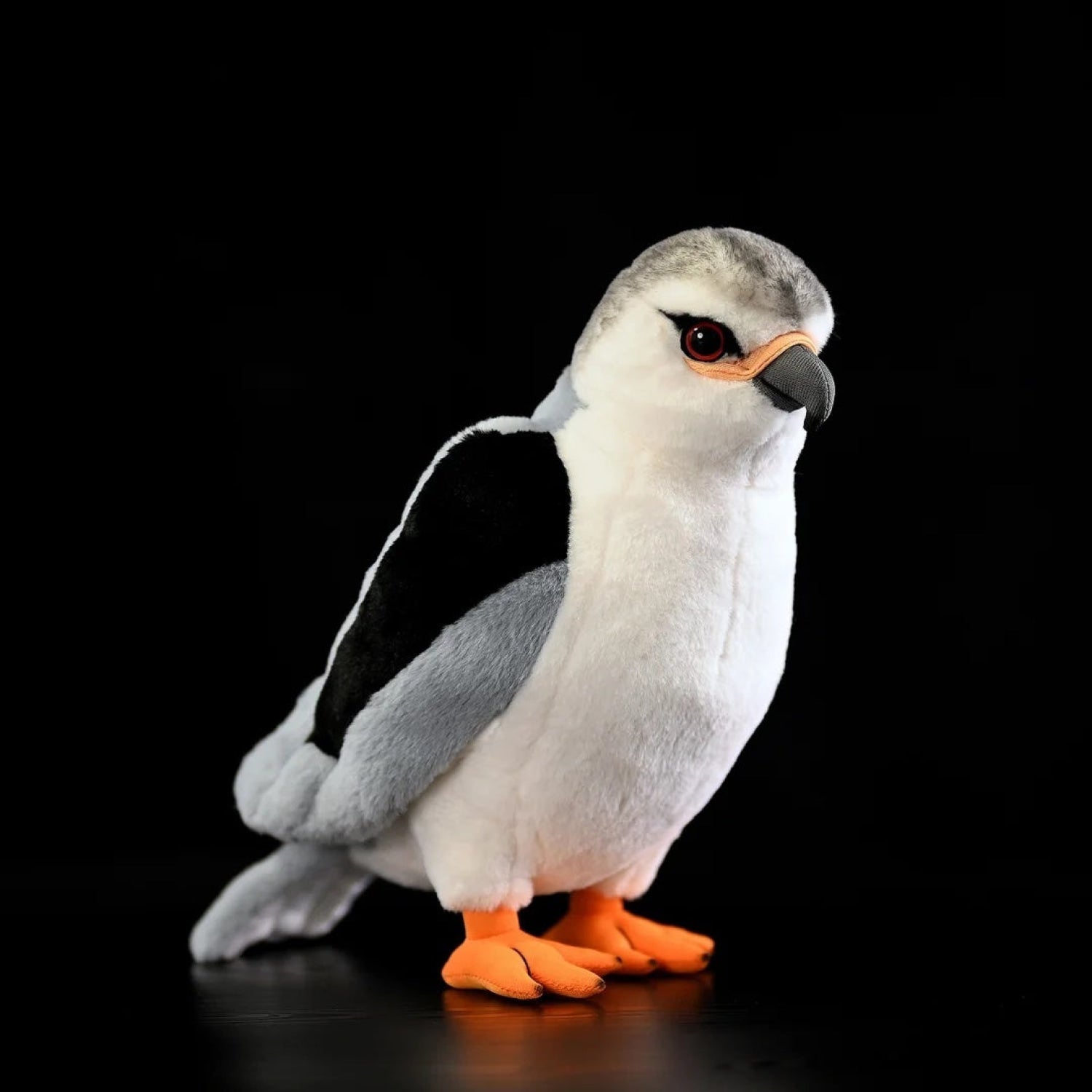 Lifelike black-winged kite plush toy with realistic grey wings, black patches, and orange feet