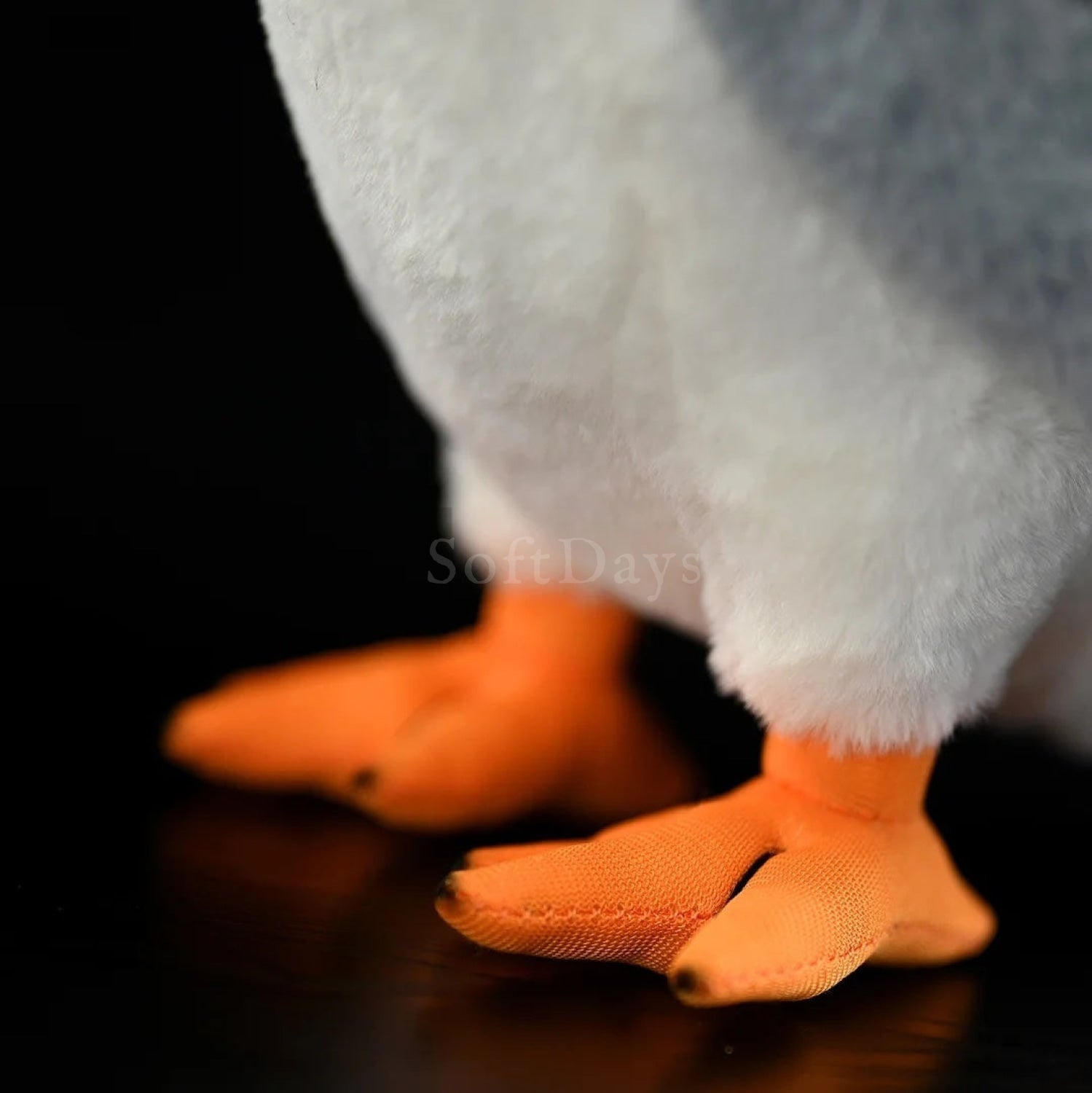 Close-up of black-winged kite plush toy’s orange feet, showcasing realistic craftsmanship
