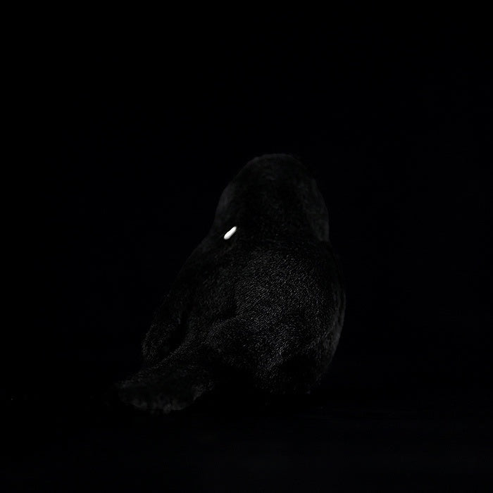 Rear view of the chubby carrion crow plush toy, highlighting its soft and cozy design