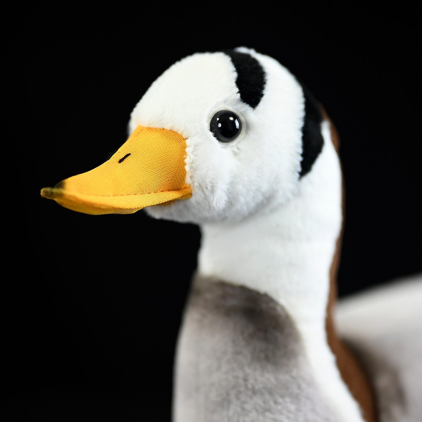 Detailed close-up of the Bar-headed Goose plush toy's face and beak, showing lifelike craftsmanship