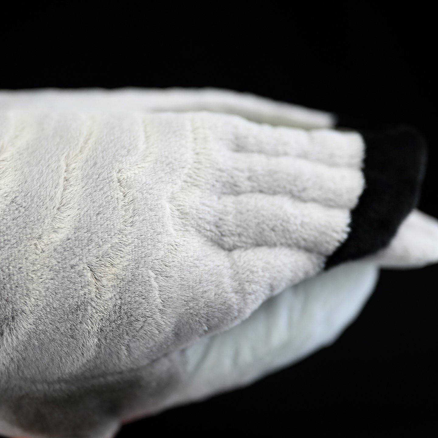 Close-up of the wings on a Bar-headed Goose plush toy, highlighting soft fabric and realistic texture