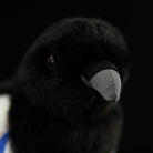 Close-up of the black-billed magpie plush toy's beak, highlighting its realistic texture and authentic design