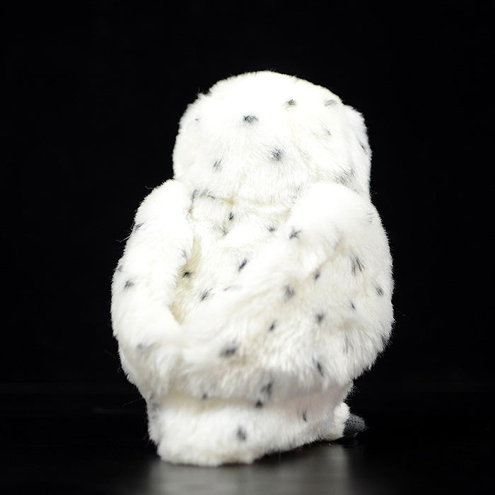 Rear side of snowy owl stuffed animal, highlighting realistic black speckles and cuddly texture