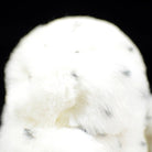 Top view of snowy owl plush toy, showing its soft fur and intricate black speckles for added realism