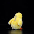 Back view of a soft yellow chick plush toy with a chain for use as a keychain or bag accessory