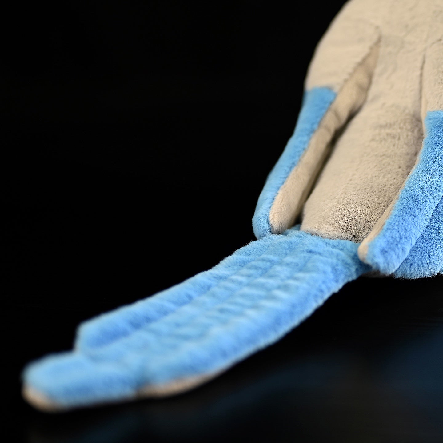 Close-up of the azure-winged magpie plush toy's long, detailed azure tail