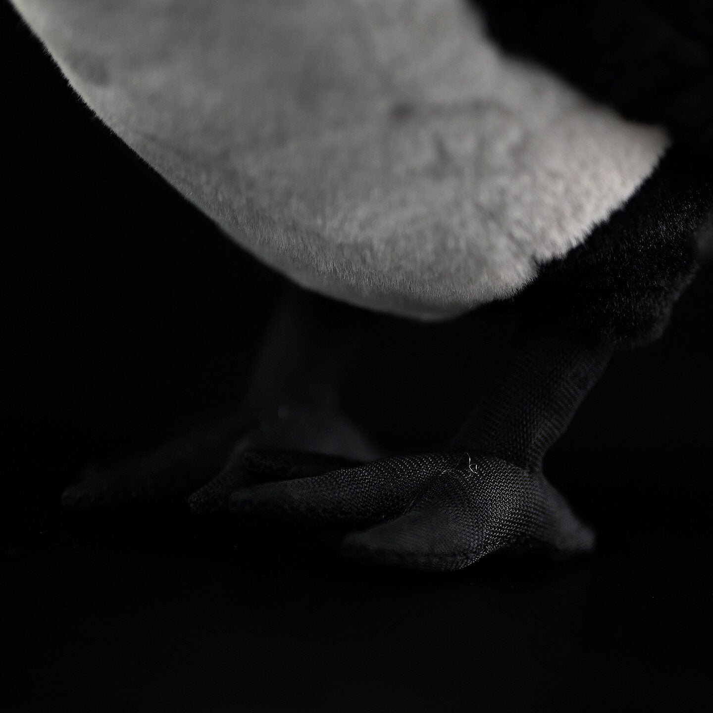 Close-up view of Daurian Jackdaw plush feet with fine stitching and realistic texture for bird enthusiasts
