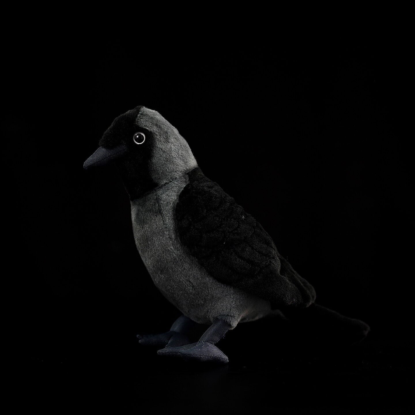 Lifelike plush of a Western Jackdaw with realistic details, mimicking the bird’s iconic dark gray and black tones