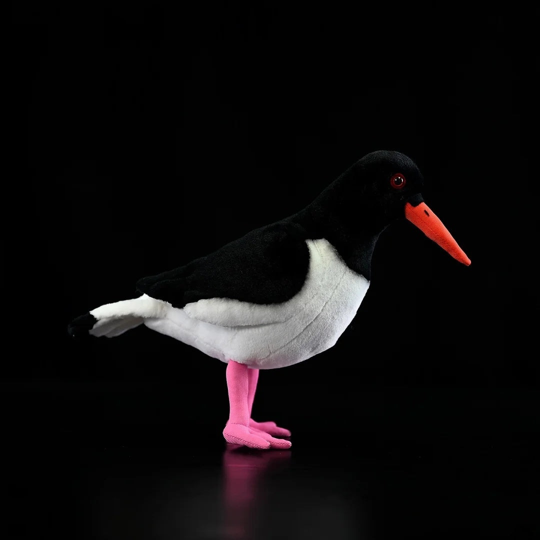 Side view of Eurasian Oystercatcher plush by SoftDaysLab®, featuring black-and-white plumage and pink legs