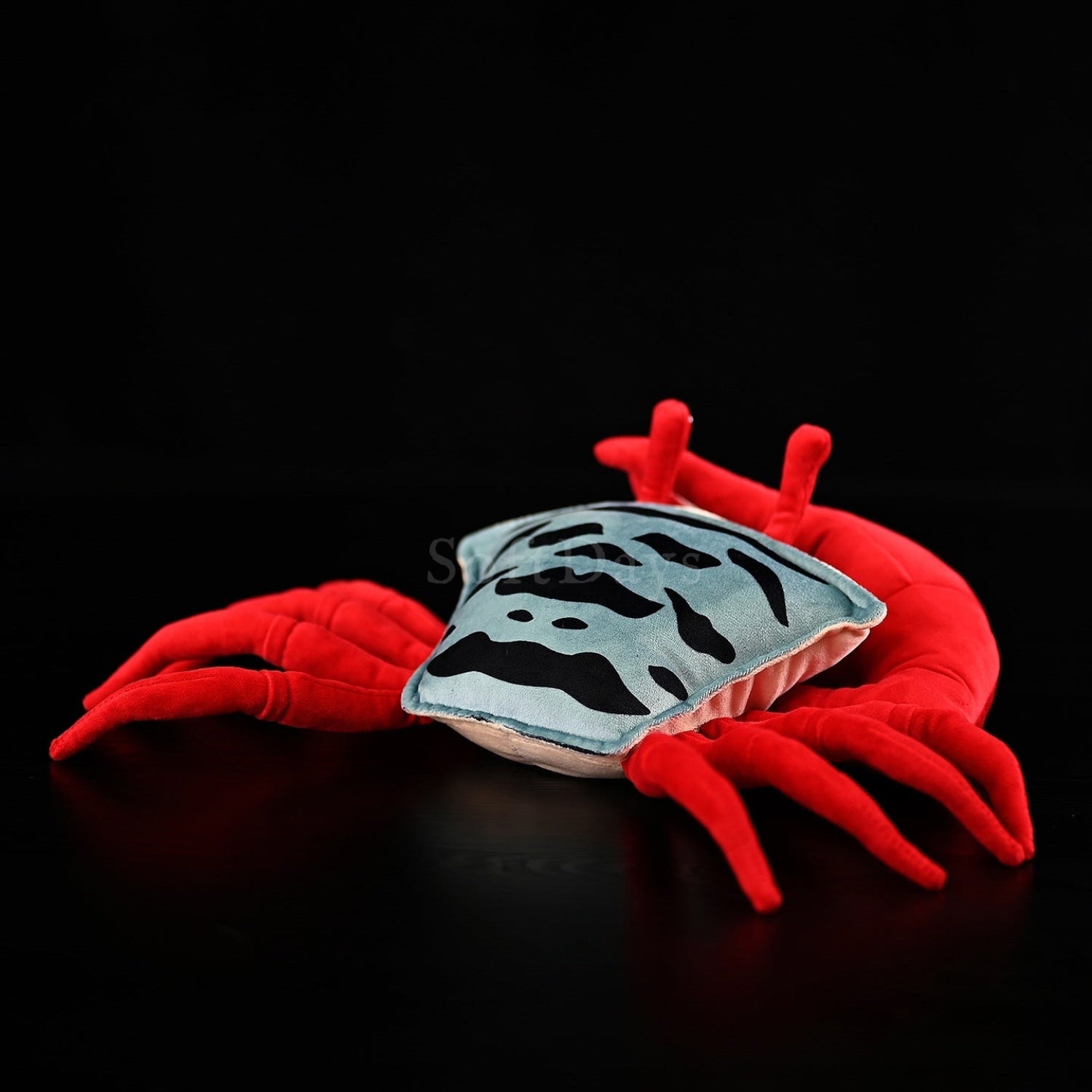 Back view of fiddler crab plush toy showcasing its patterned shell in realistic marine animal design