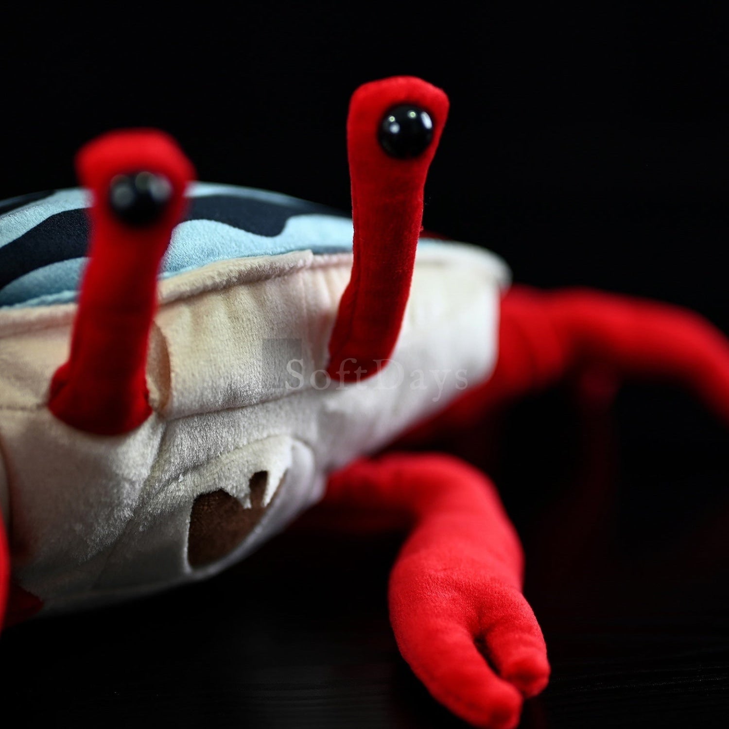 Close-up of fiddler crab plush eyes and soft fabric details, a cute marine animal toy for kids and collectors