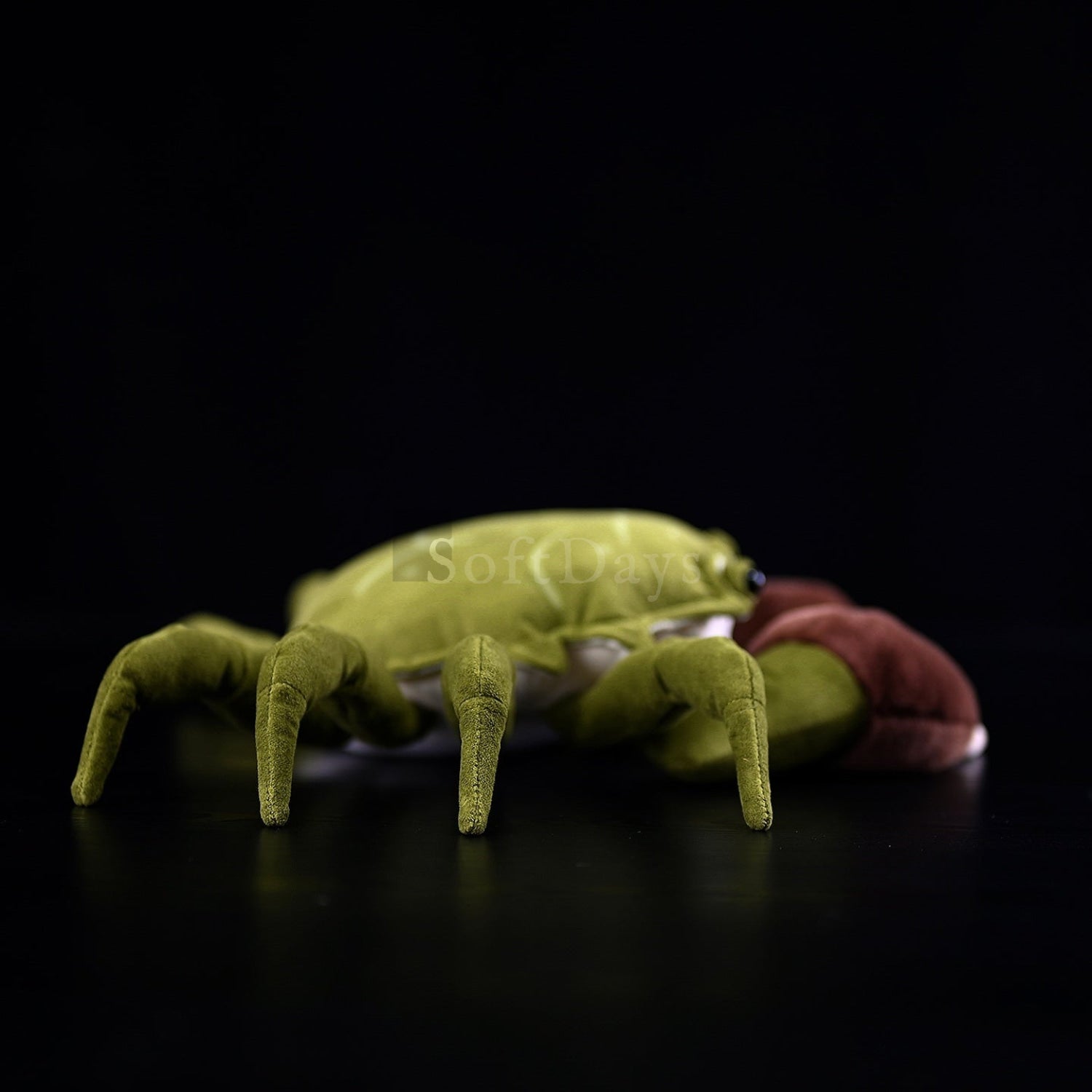 Side view of a Chinese mitten crab stuffed animal showcasing realistic legs and soft fabric design