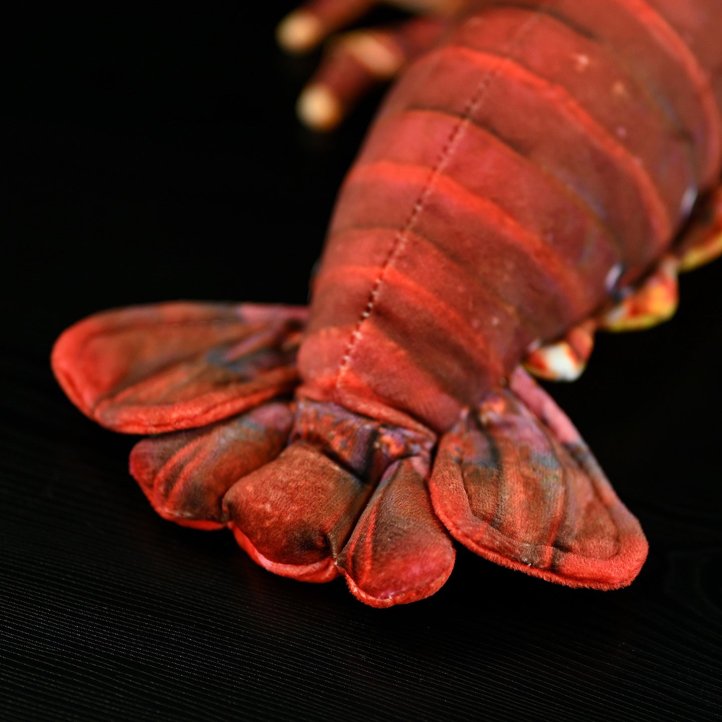 Tail detail of Japanese spiny lobster plush toy, featuring soft fabric and lifelike patterns