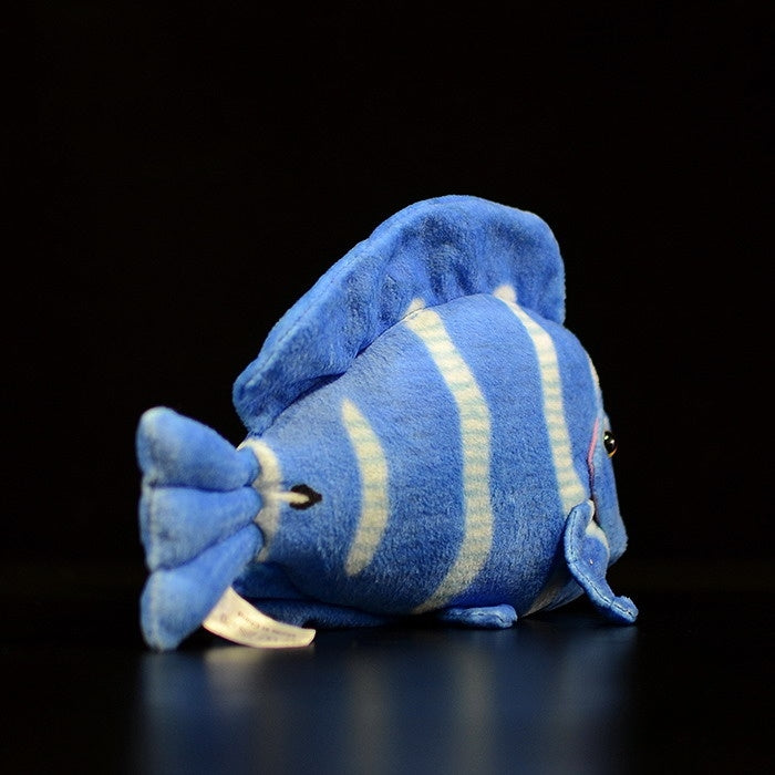 Side view of a soft blue tang fish plush toy with vibrant stripes and realistic marine animal design by SoftDaysLab