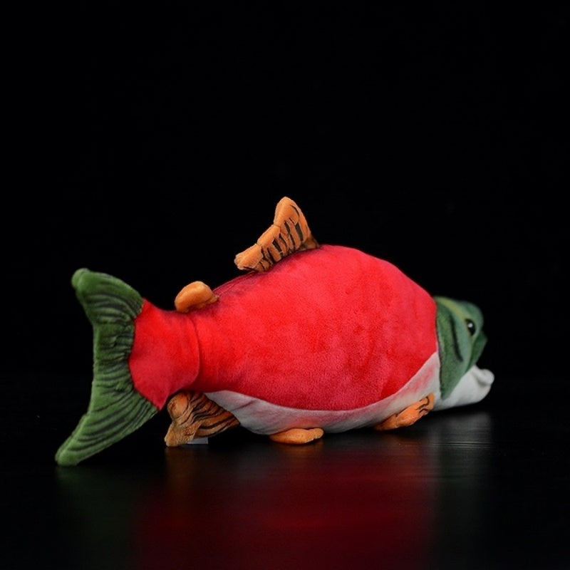 Rear angled view of a sockeye salmon plush toy, showing its tail and dorsal fin details