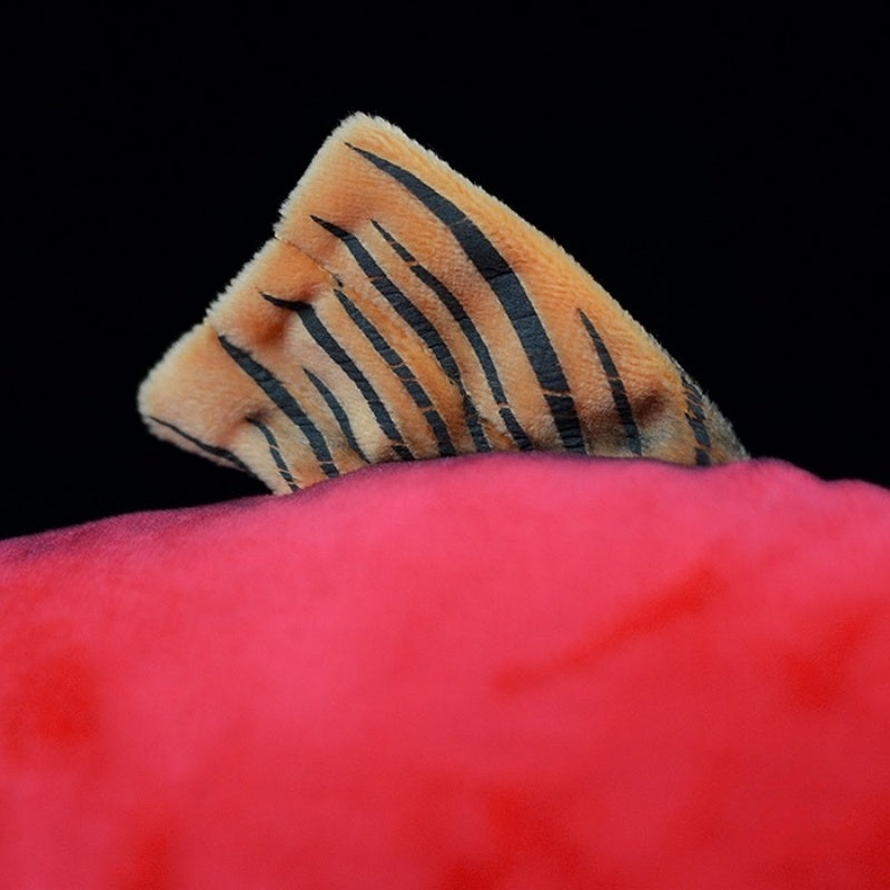 Close-up of the dorsal fin of the sockeye salmon plush toy, showcasing its intricate striped design