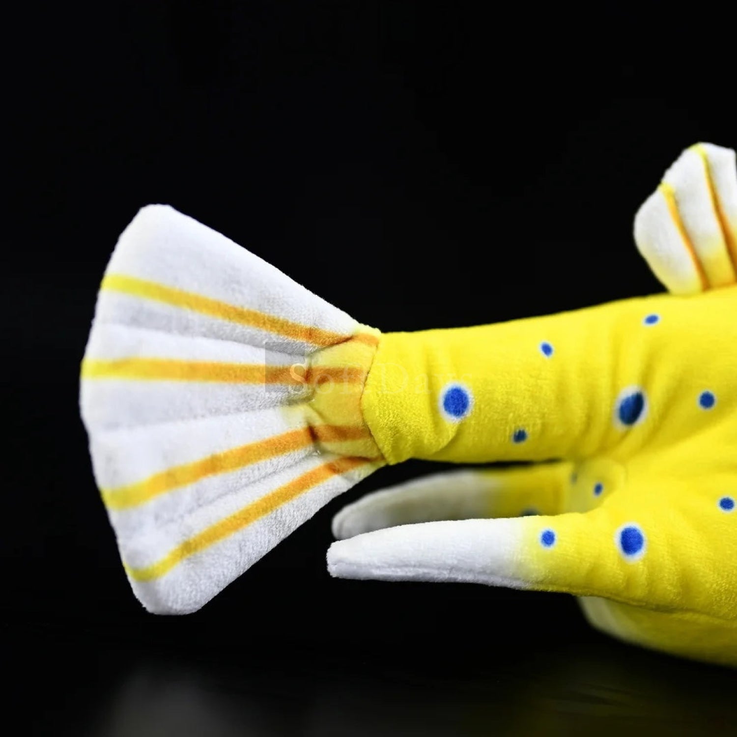 Close-up of realistic Longhorn Cowfish plush toy’s tail with bright stripes and realistic texture