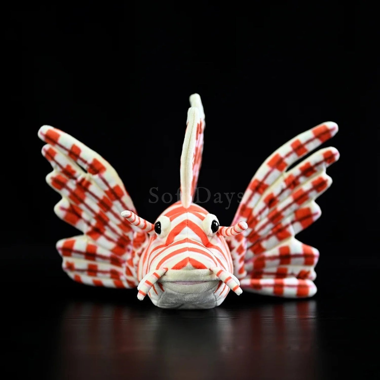 Head-on view of red lionfish plush showcasing lifelike design and striking striped pattern