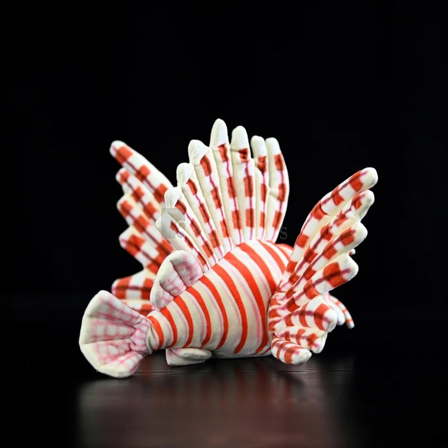 Rear view of red lionfish plush toy with vibrant red-and-white stripes and lifelike flowing fins