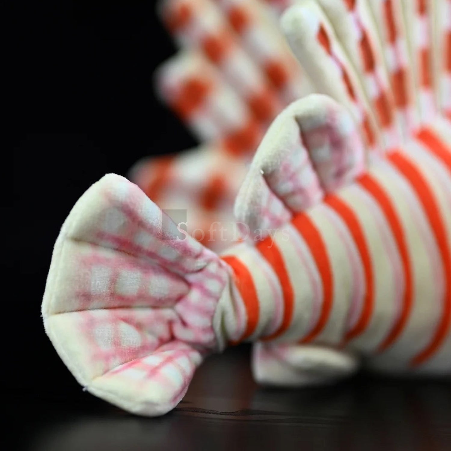 Detailed view of red lionfish plush toy’s fin, showcasing realistic texture and striped pattern